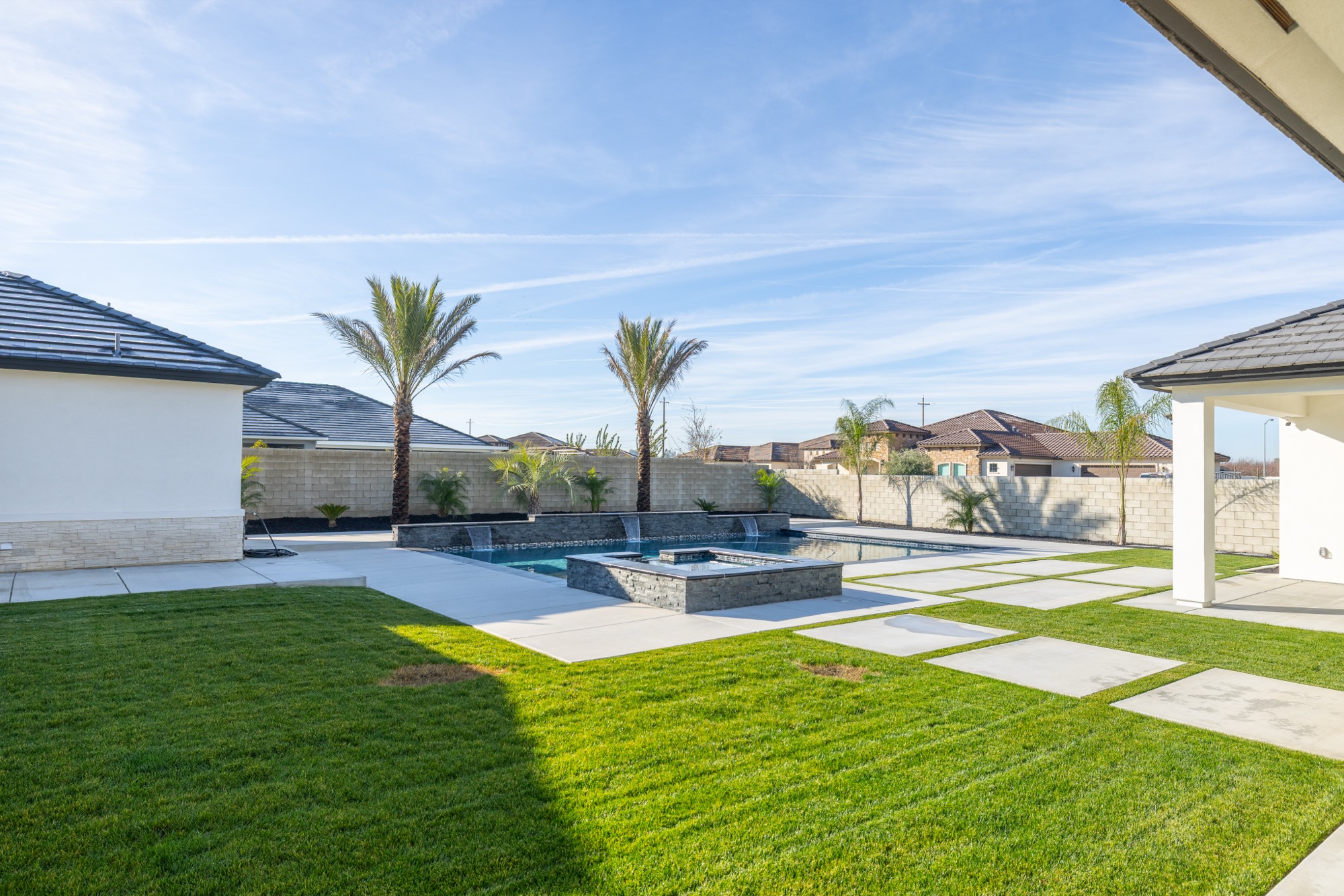 Custom gunite pool with fire pit, palms, and wide backyard — Bakersfield, CA